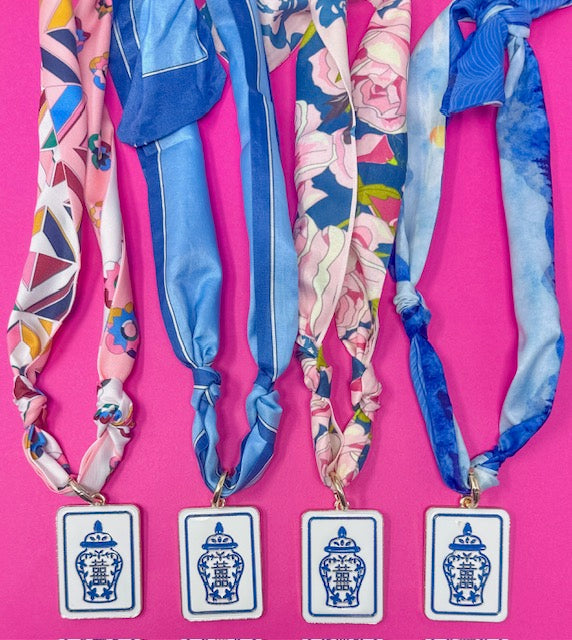 Colorful headbands with floral and geometric patterns on a pink background
